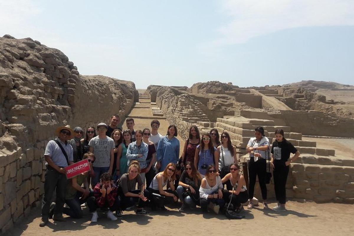 a group of people posing for a picture at a pyramid