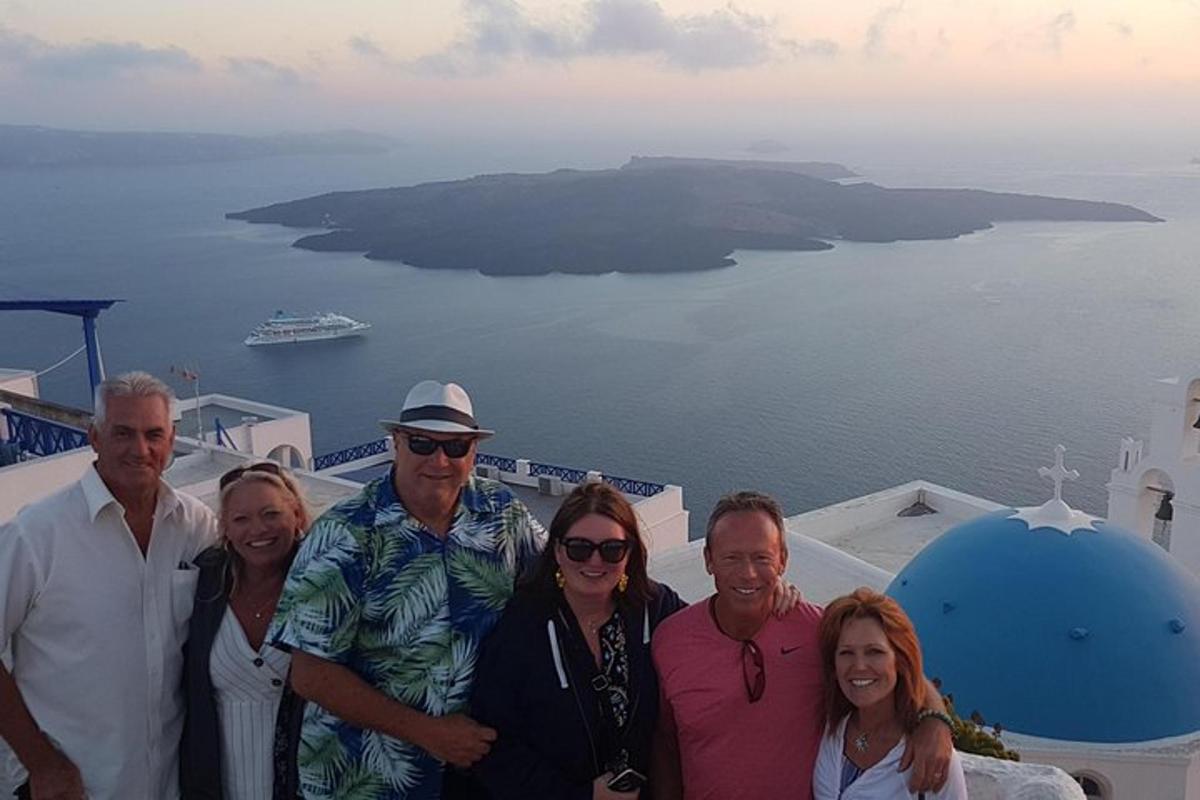 a group of people posing for a picture on top of a building