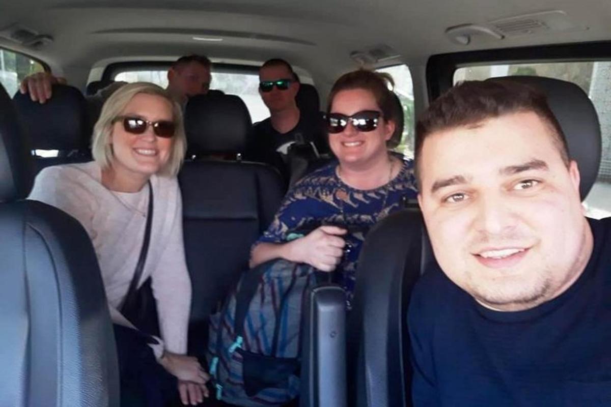 a group of people sitting in the back of a car