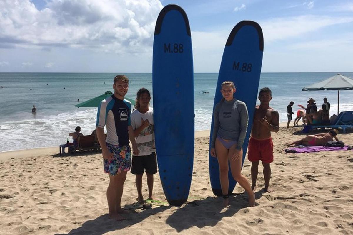 a group of people standing next to surfboards on the beach