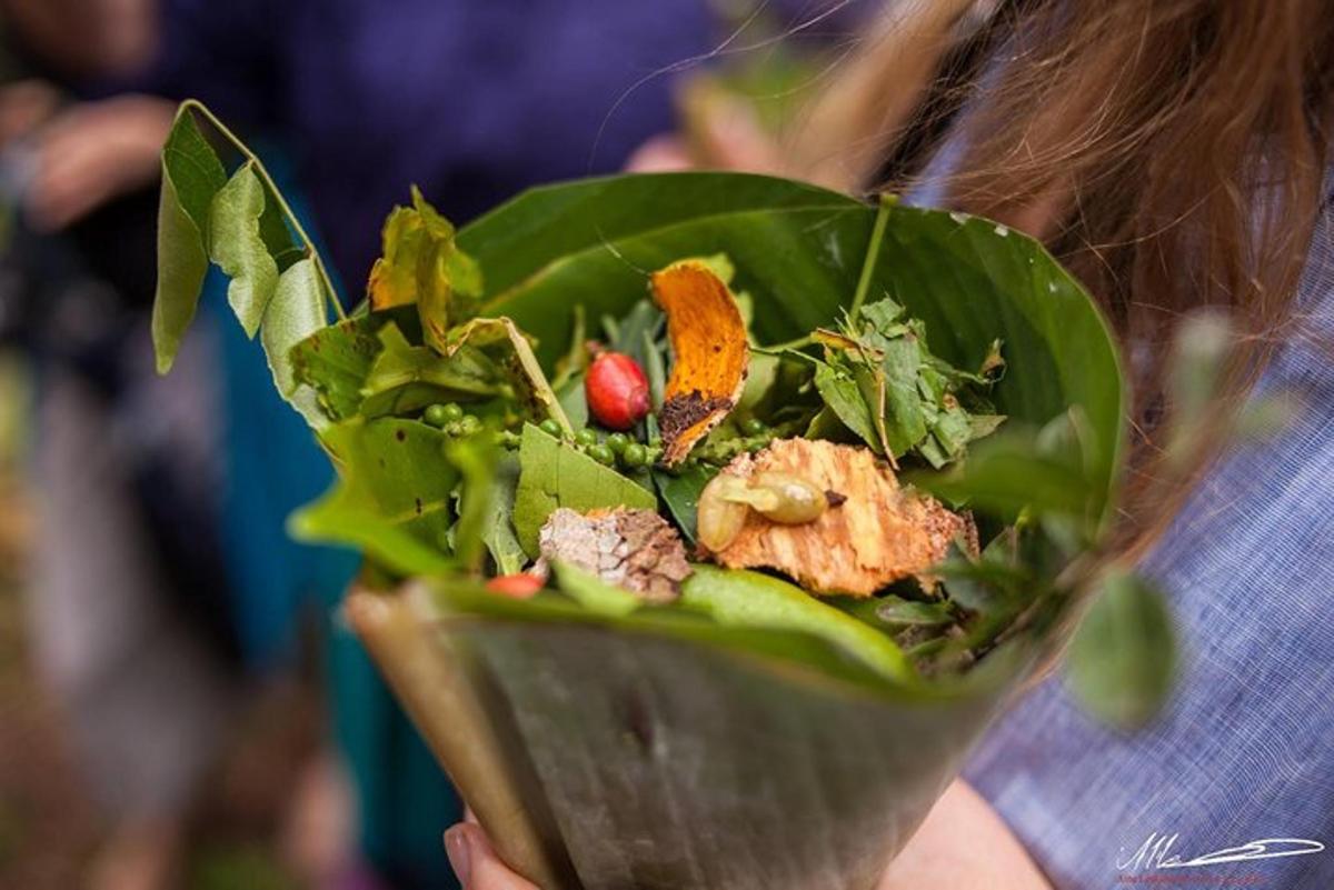 a woman holding a salad in a green leaf