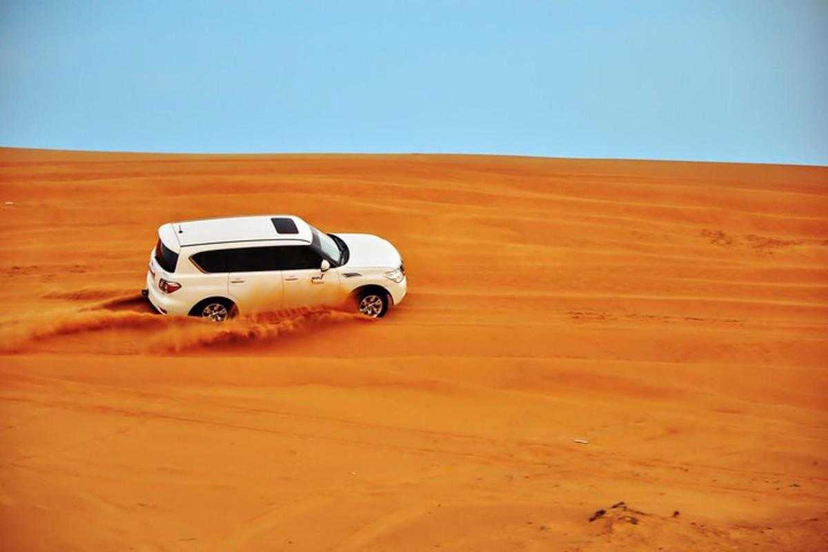 a white suv driving through the desert