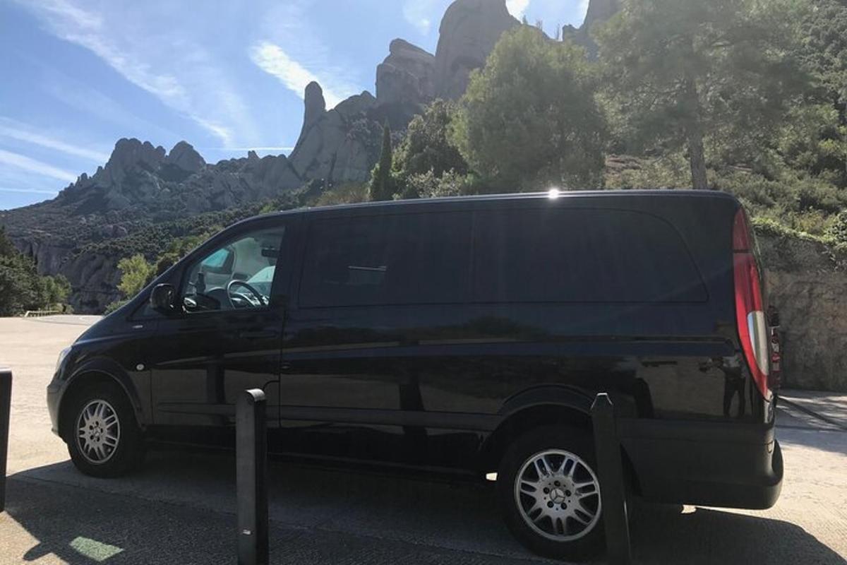 a black van parked in front of a mountain