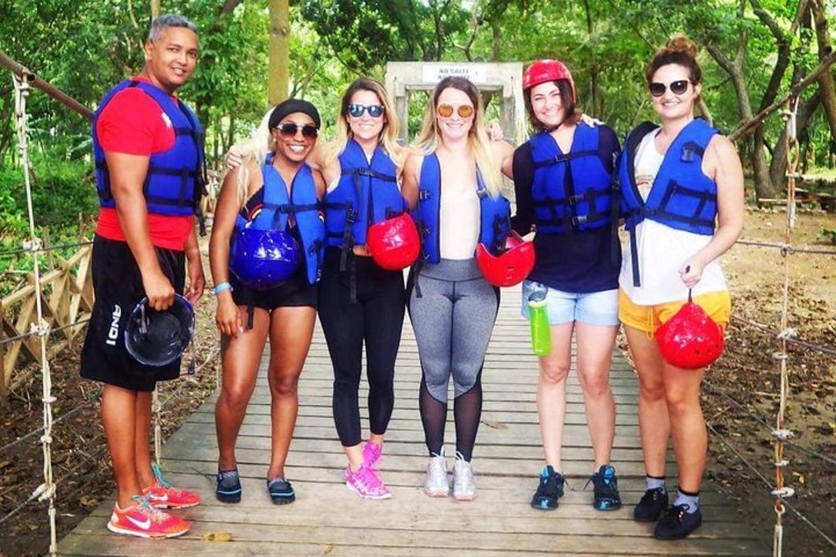 a group of people wearing life jackets standing on a bridge