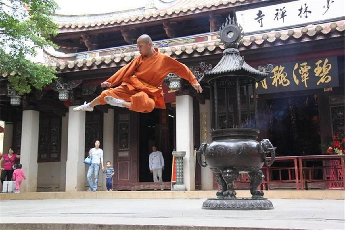 a man jumping in the air in front of a building