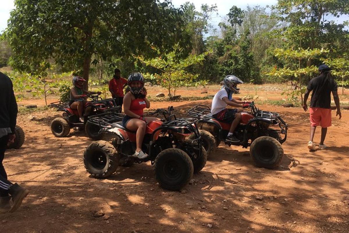 a group of people riding atvs on a dirt road