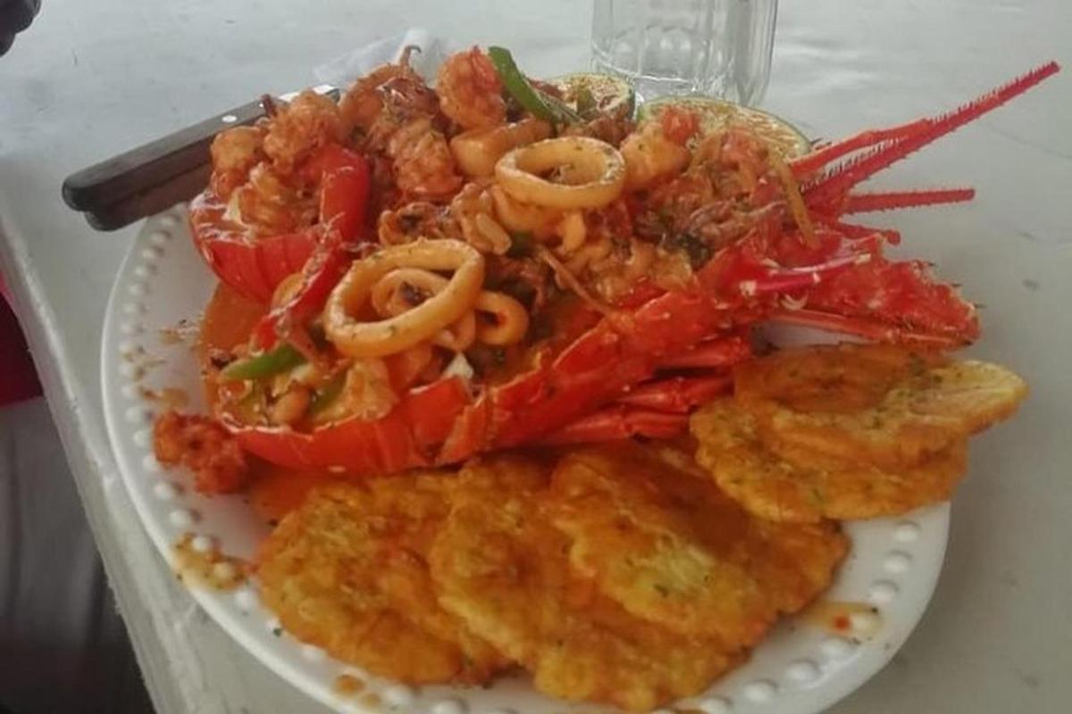 a plate of food with shrimp and vegetables on a table