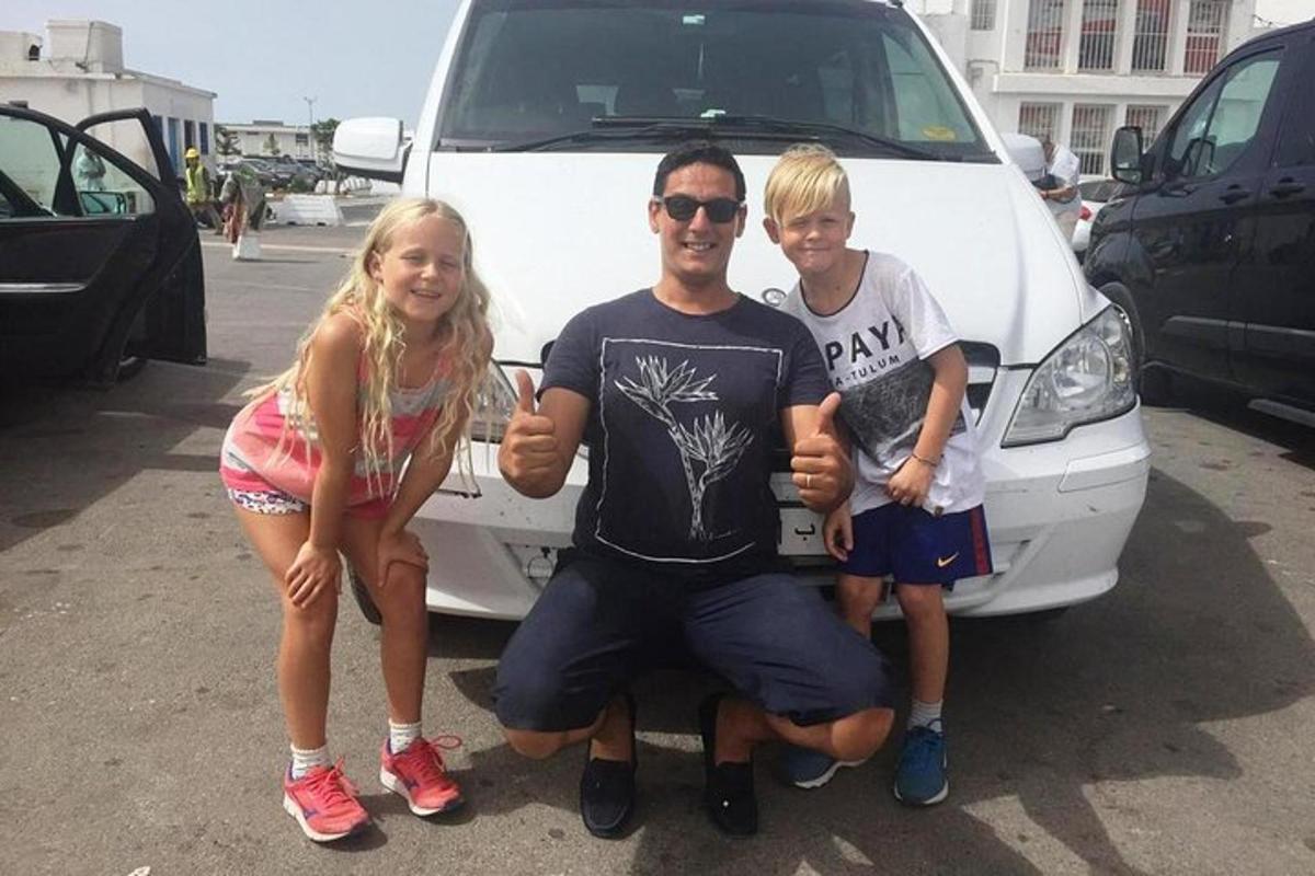 Mees ja kaks last seisavad kaubiku ees