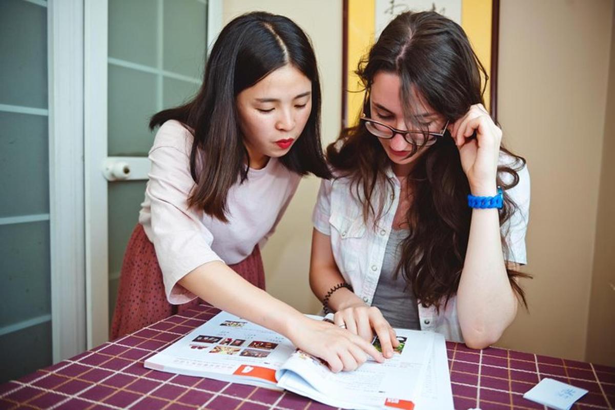 two women looking at a paper at a table