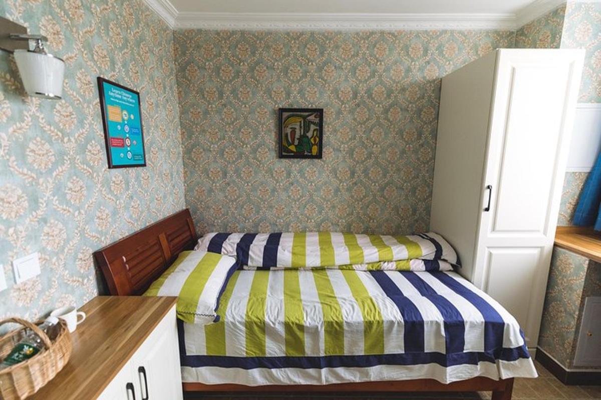 a small bedroom with a bed in the corner