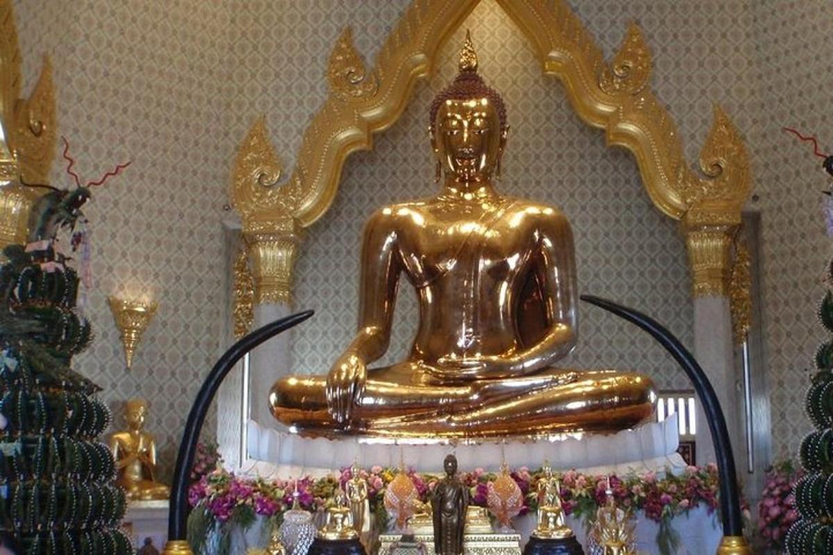 a gold buddha statue sitting on top of a table
