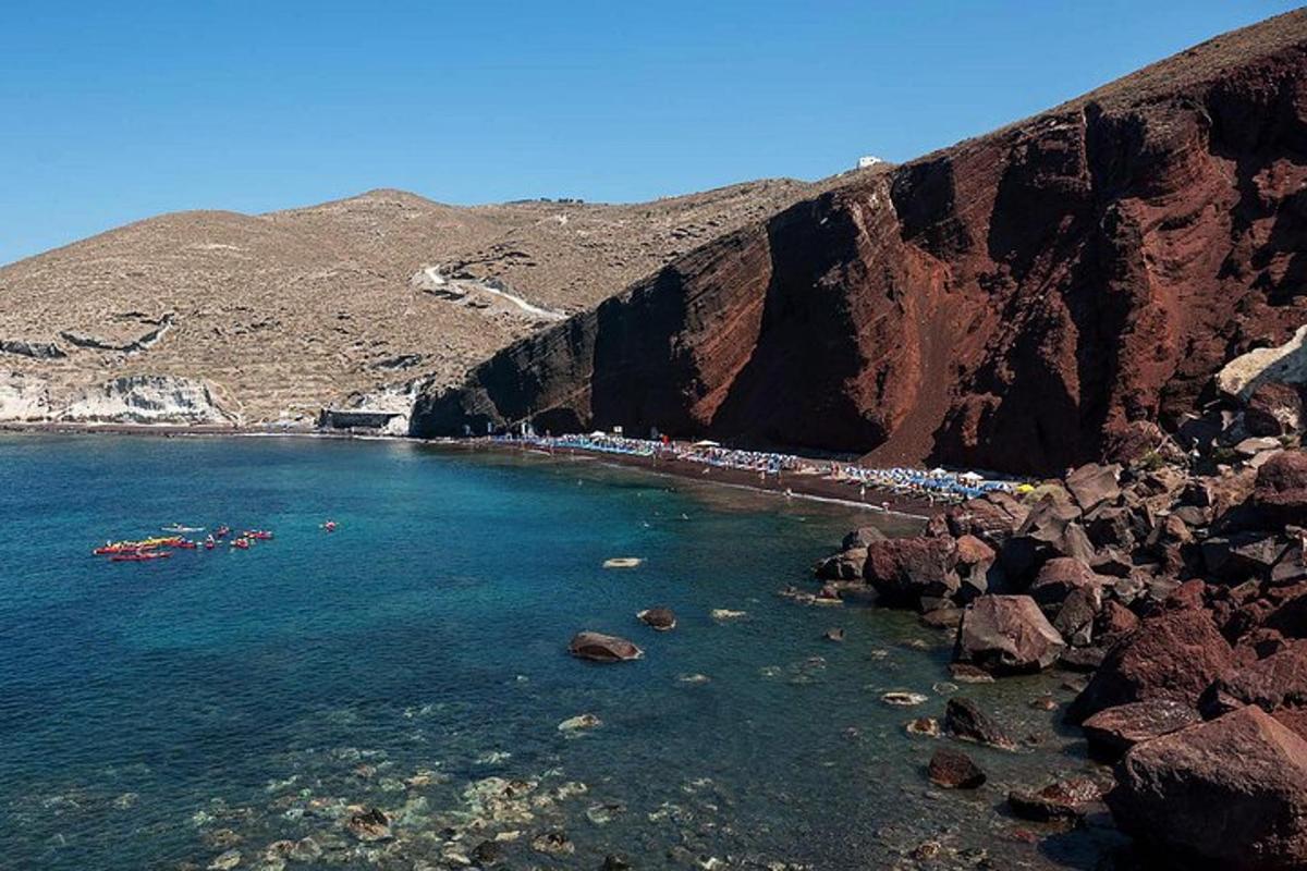 μια ομάδα ανθρώπων σε μια παραλία δίπλα σε ένα βουνό