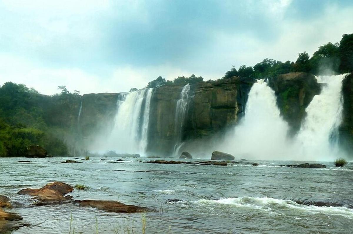 a large waterfall in the middle of a river
