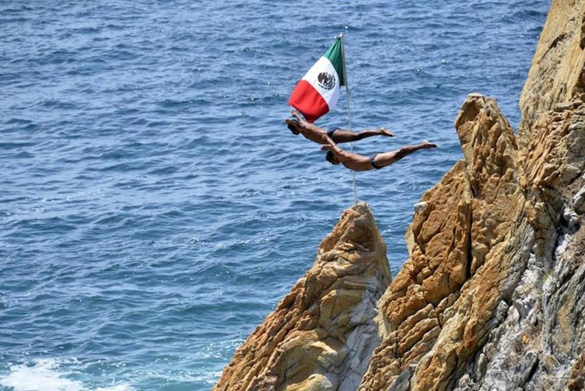 a person diving into the ocean with a flag