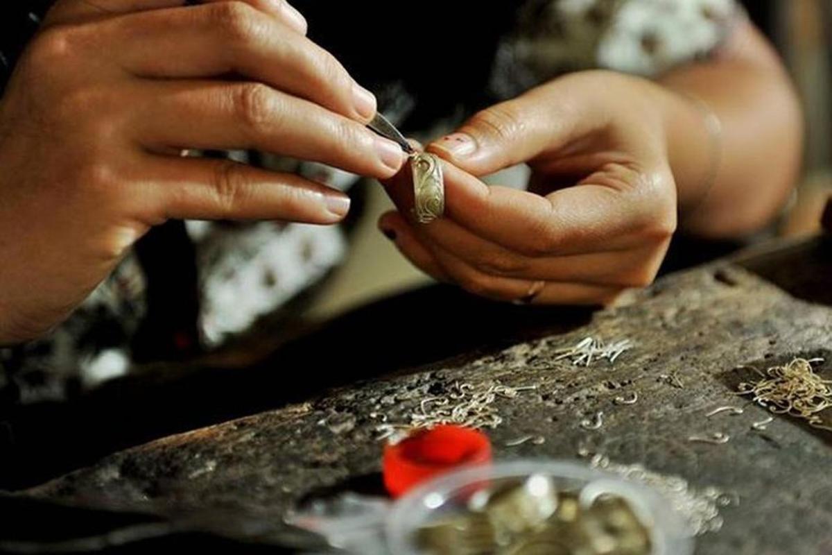 a woman is putting a ring on her finger