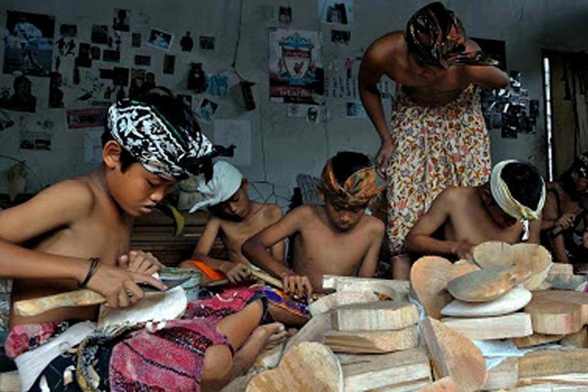 a group of children sitting around a table in a room