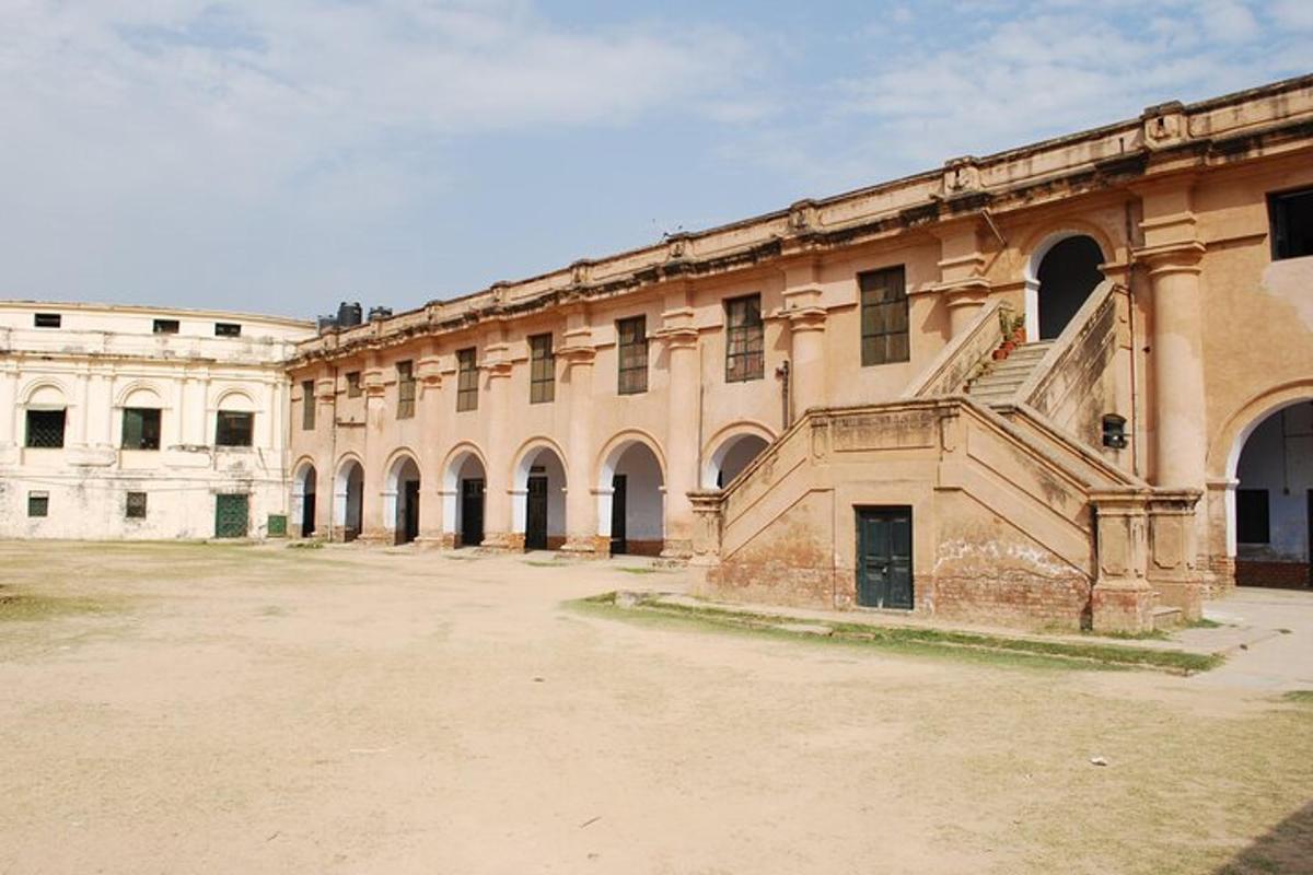 a large building with a staircase in a courtyard