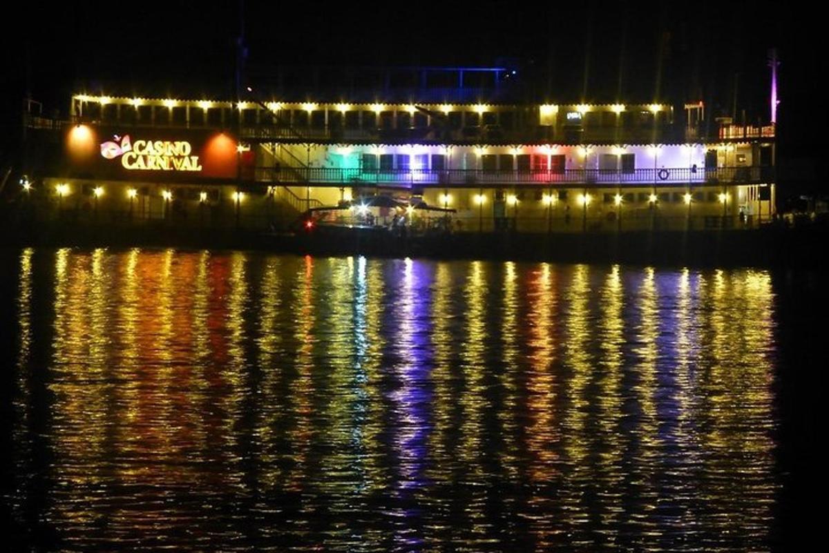 a building with lights on the water at night