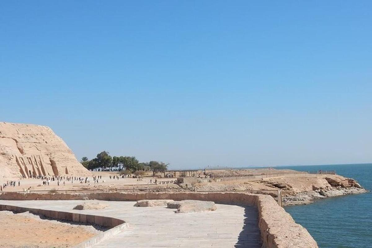 a walkway on a beach next to the water
