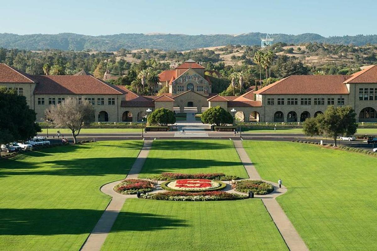 a campus with a green lawn and a large building