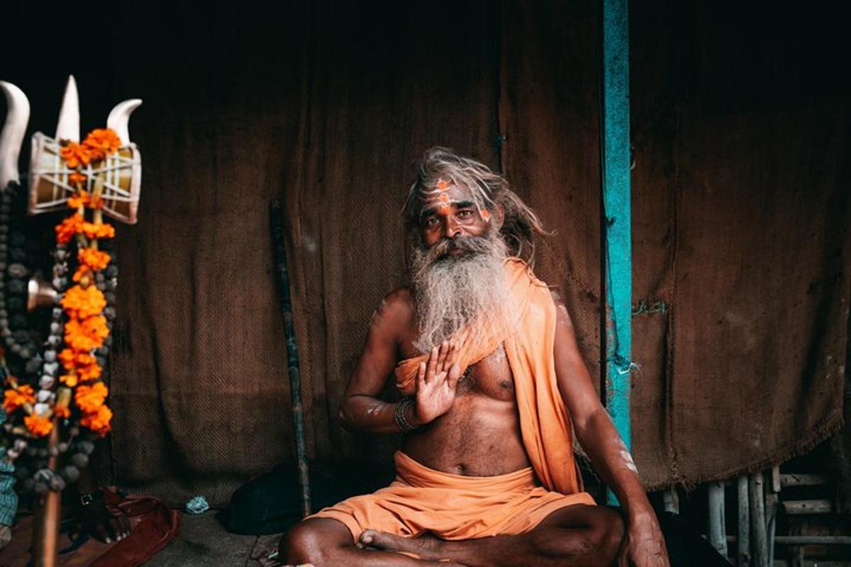um homem com uma longa barba sentado no chão
