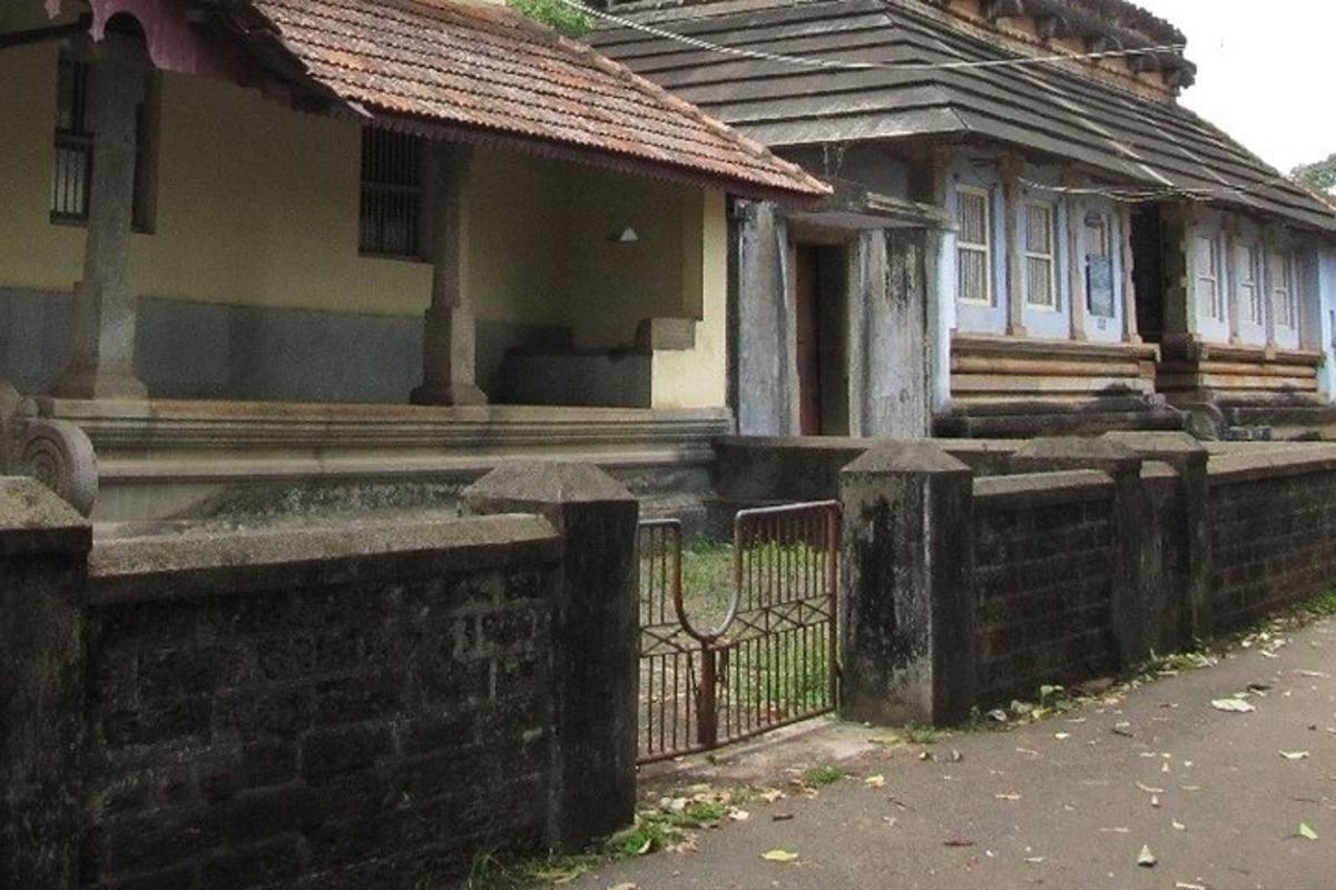 an old house with a fence in front of it