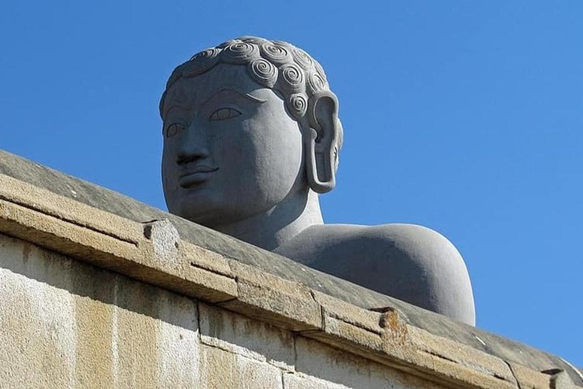 a statue of a woman sitting on top of a building