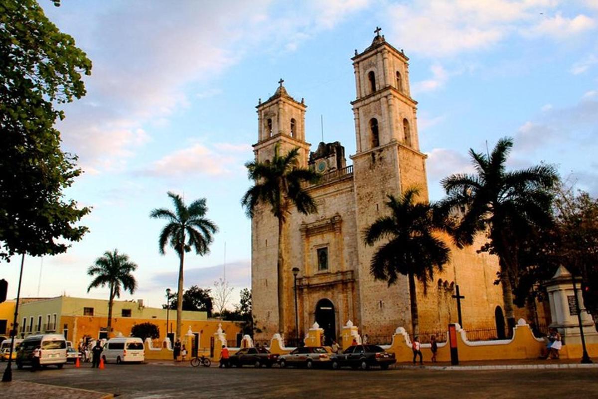 an old building with two towers and palm trees