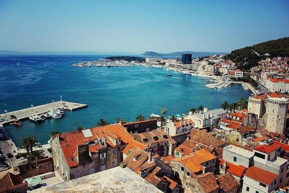 an aerial view of a city with boats in the water
