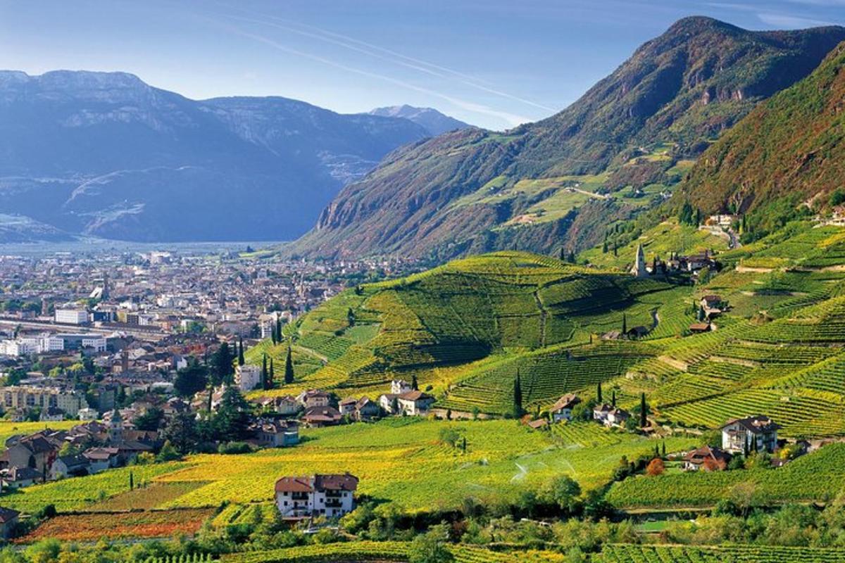 a village on a hillside with mountains in the background