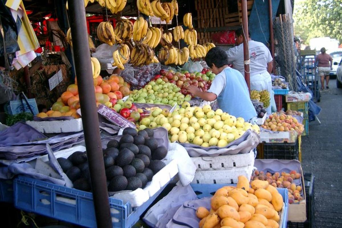 a fruit stand with fruits and vegetables on display