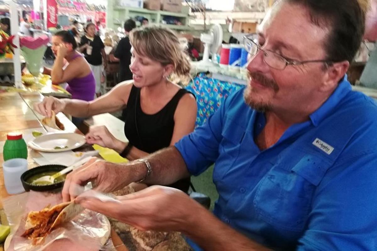 a man sitting at a table eating food