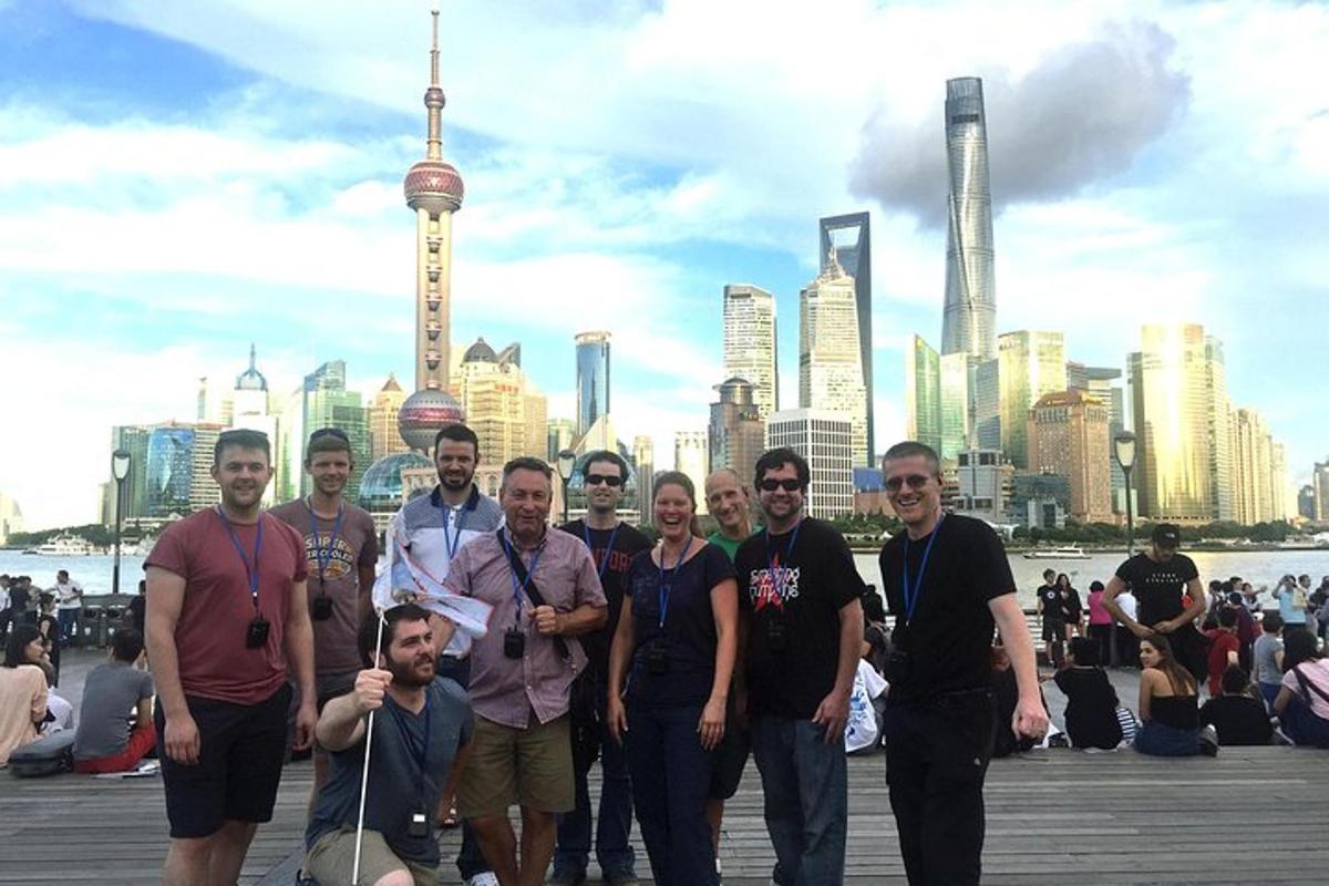 a group of people posing for a picture in front of a city