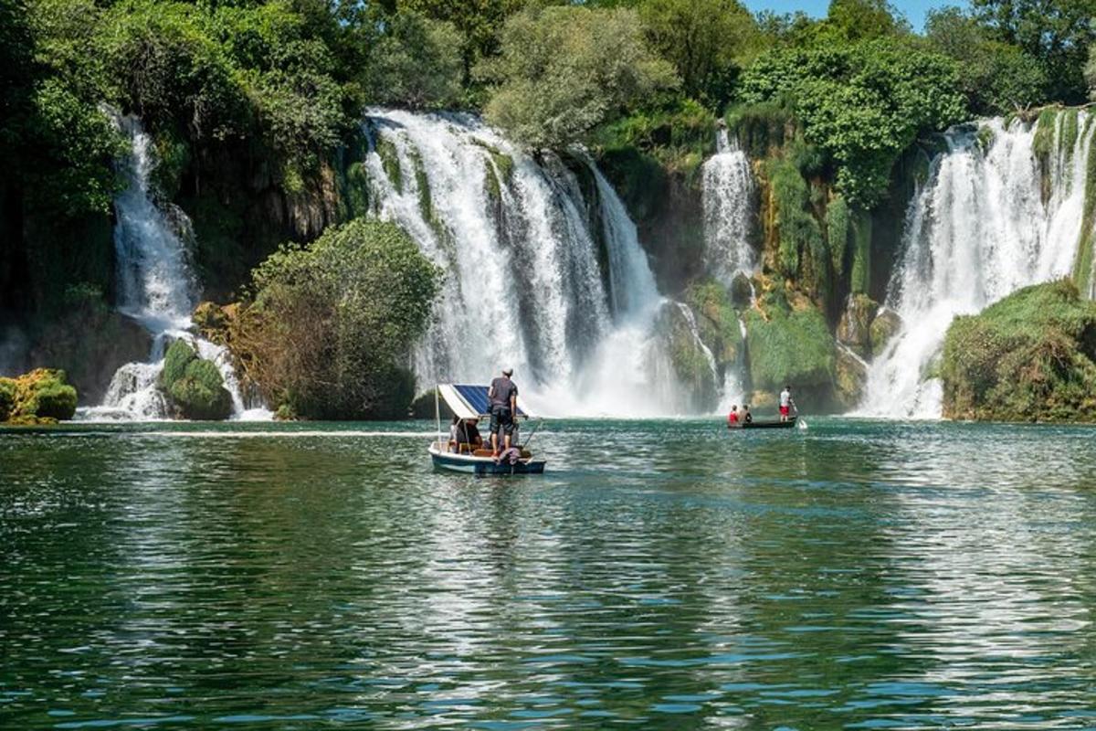 due barche in acqua davanti a una cascata