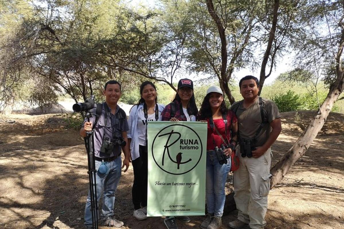 a group of people standing next to a sign