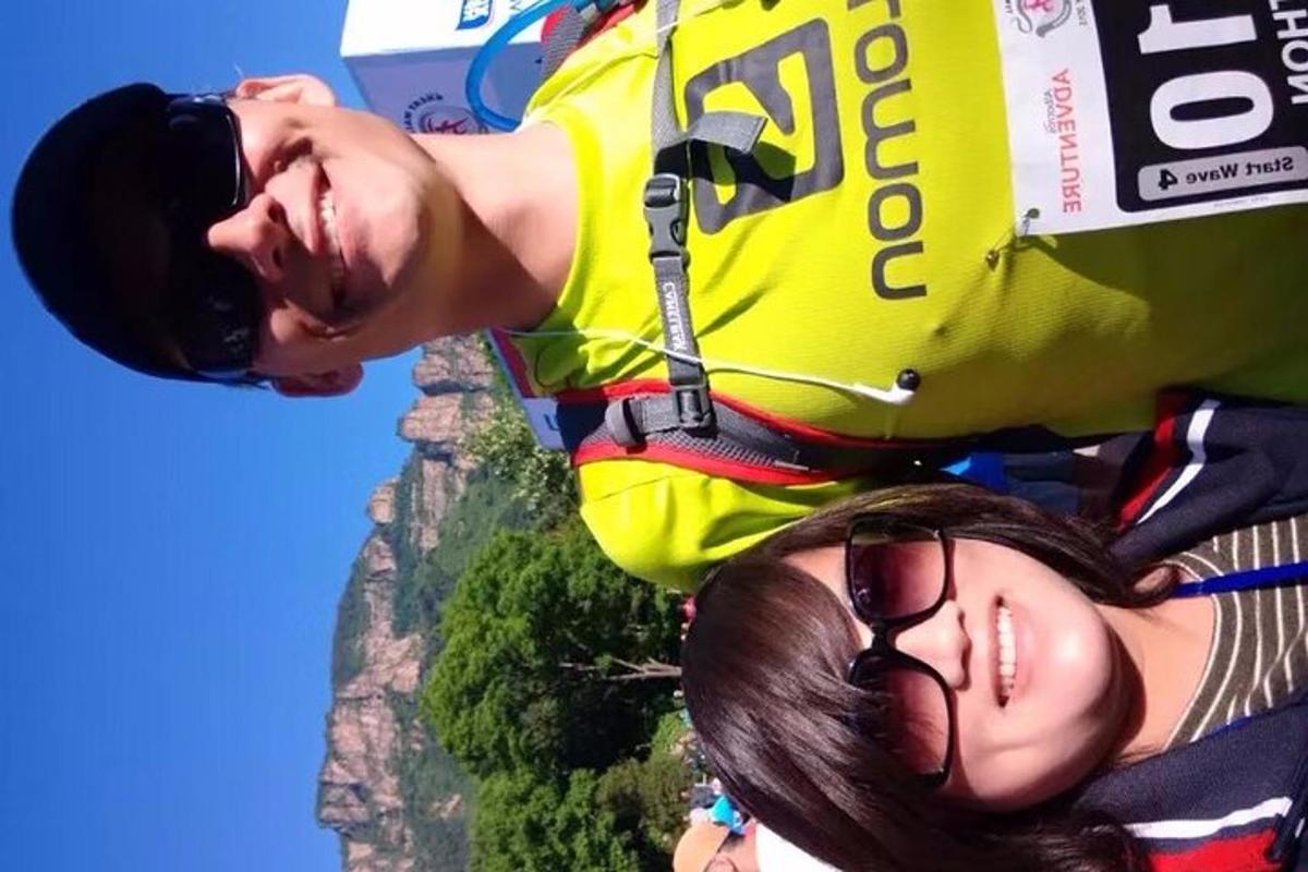 a man and a woman standing on the edge of the mountain