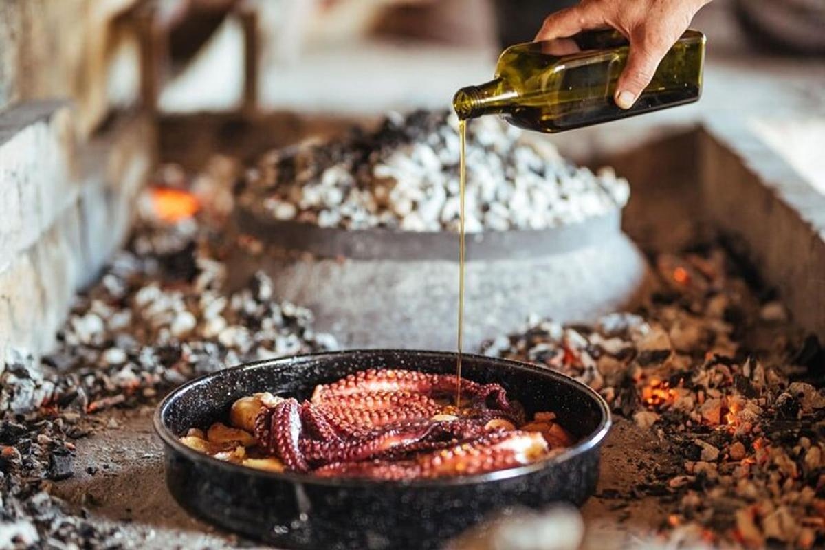 a person is pouring oil into a pan of food