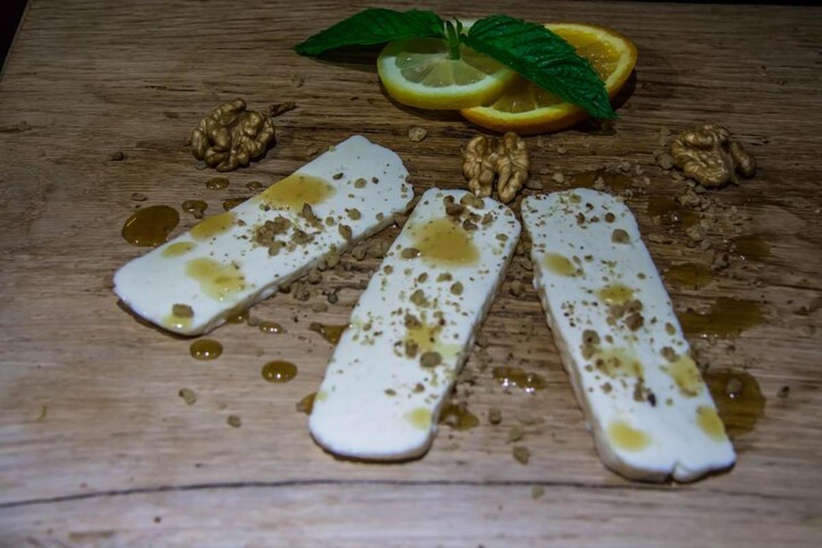 a close up of three pieces of cheese with lemon slices