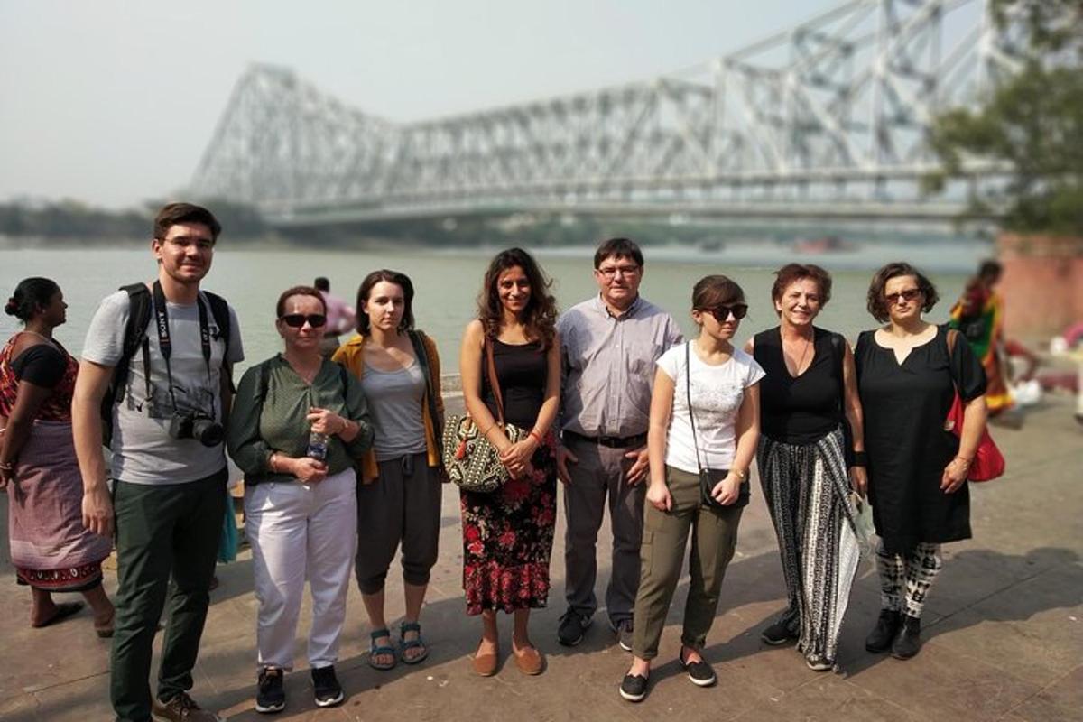 a group of people standing in front of a bridge