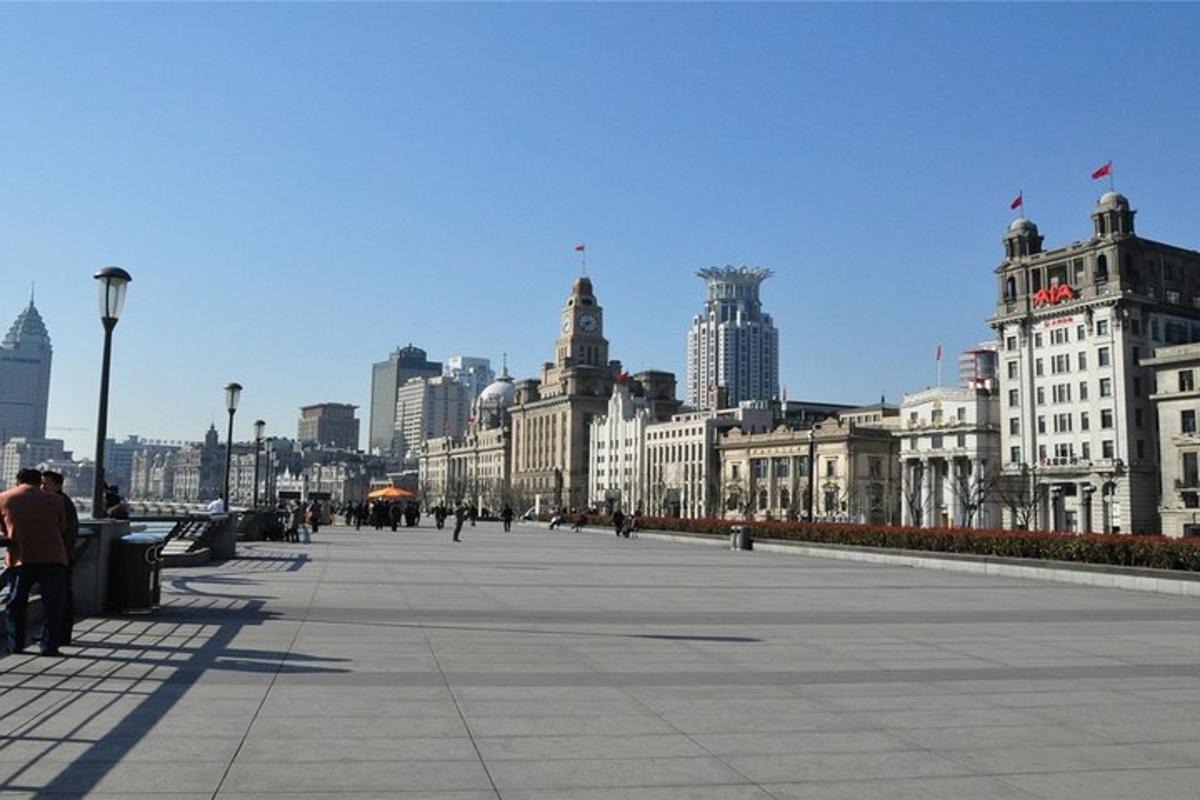 a city with buildings and people walking on a sidewalk