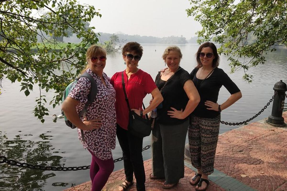a group of women standing next to a body of water