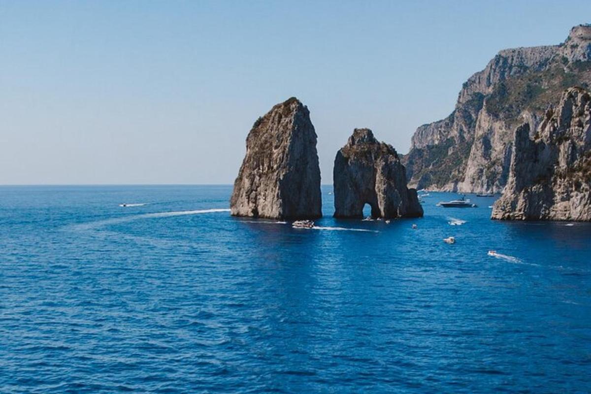 a group of rocks in the water with boats