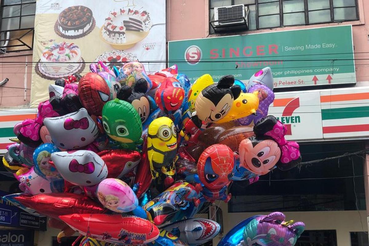 a bunch of balloons in front of a store