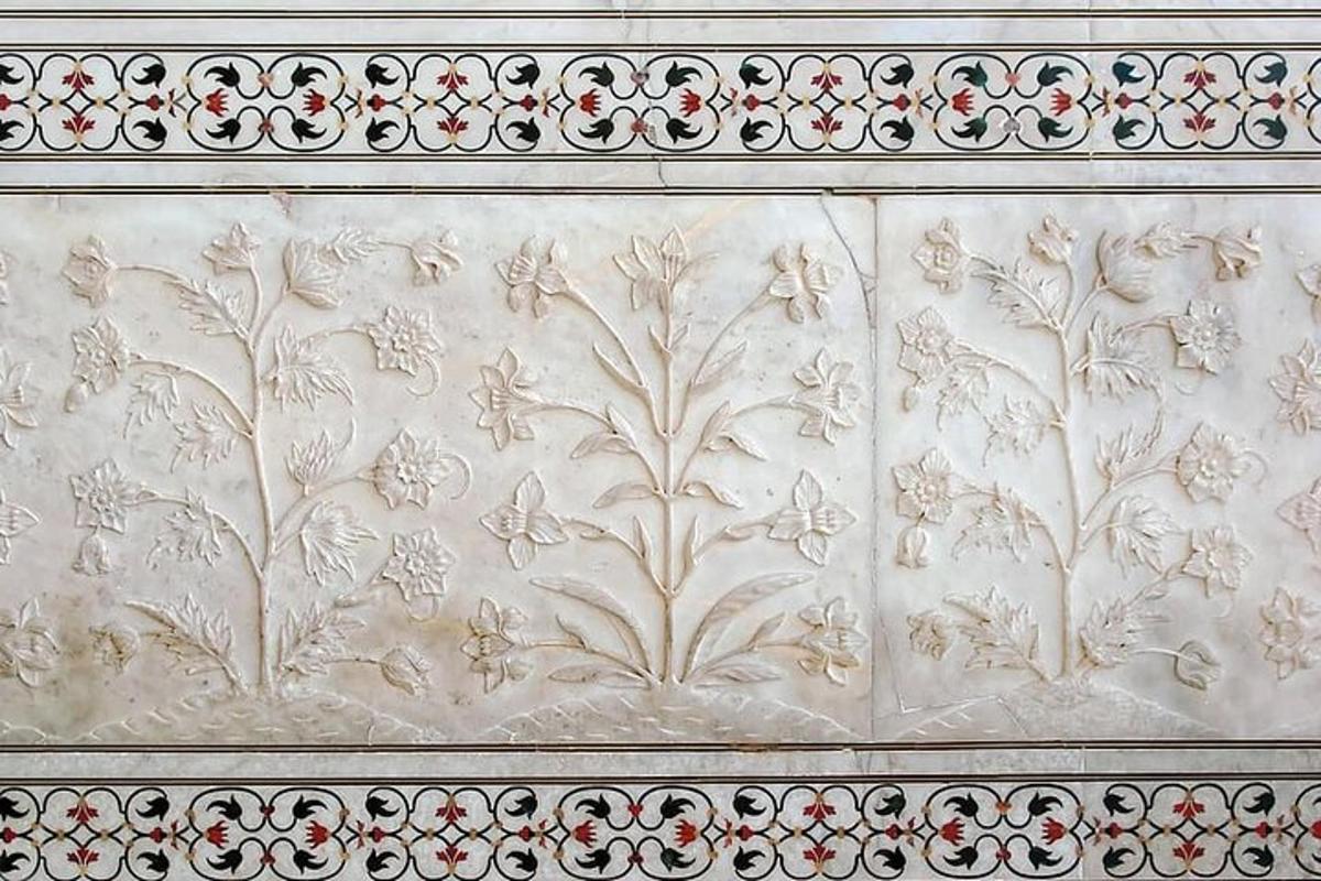 a white wall with a floral design on it