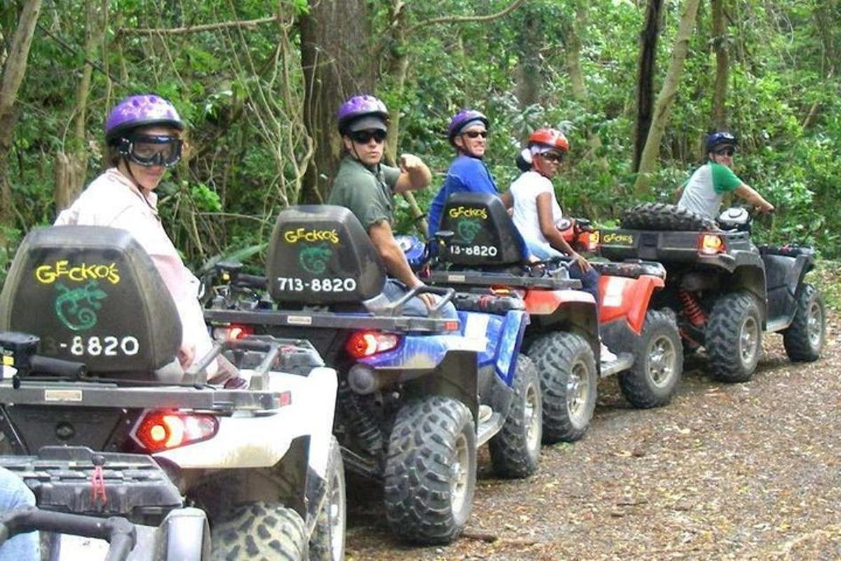 Un grupo de personas conduciendo vehículos todo terreno por un sendero.
