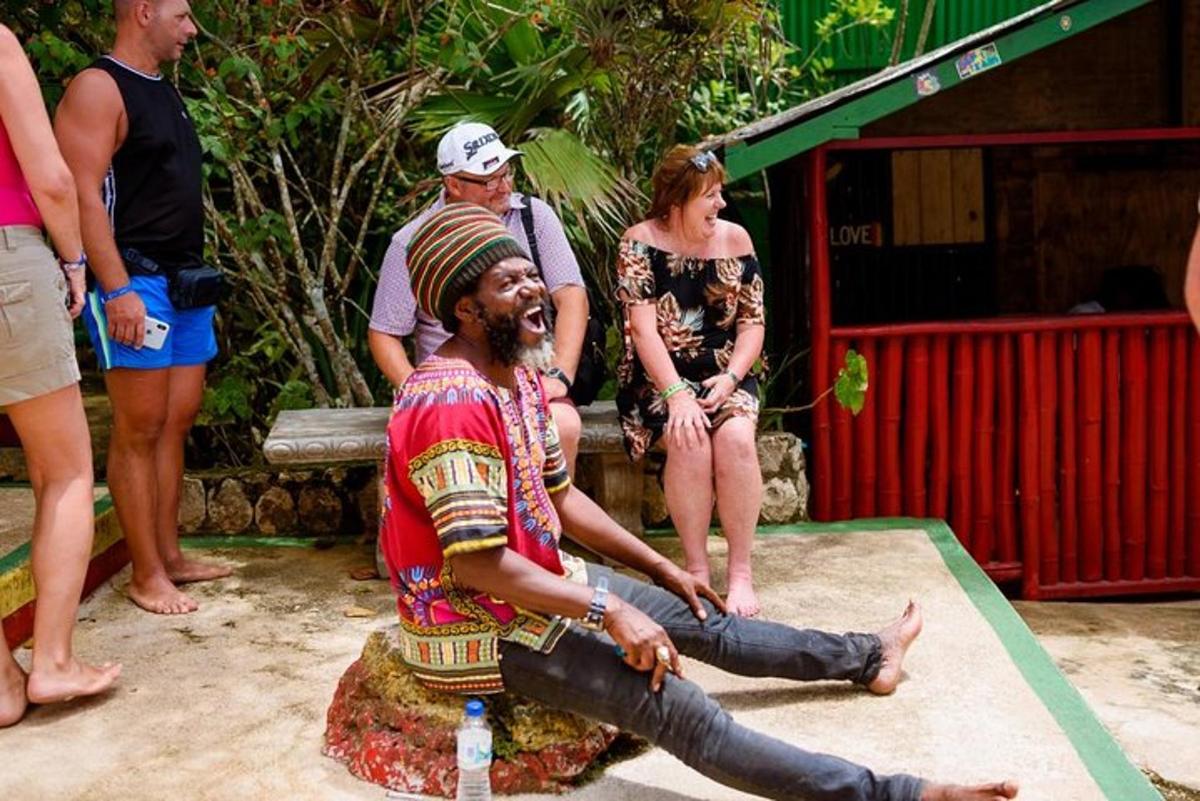 a man sitting on a rock with a group of people