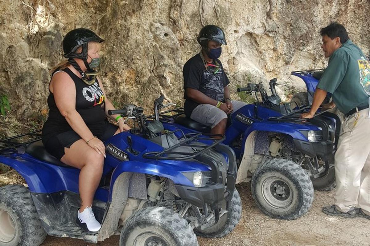 a group of people riding on four wheelers