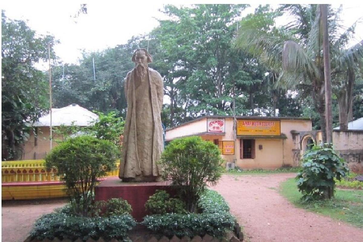 a statue of a man standing in front of a building