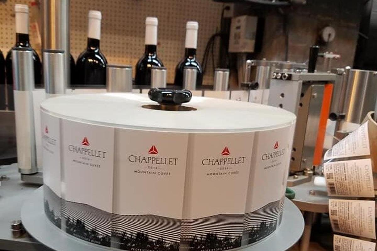a machine with bottles of wine on a table