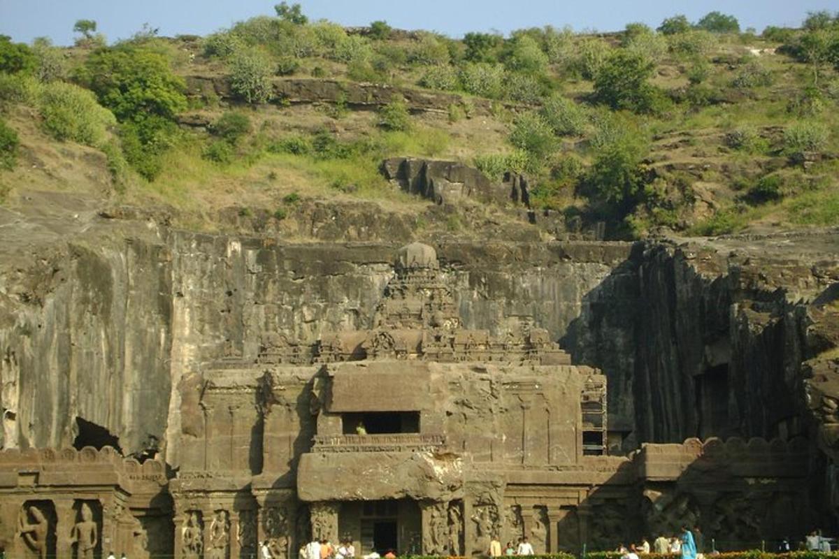 a large stone building in front of a mountain